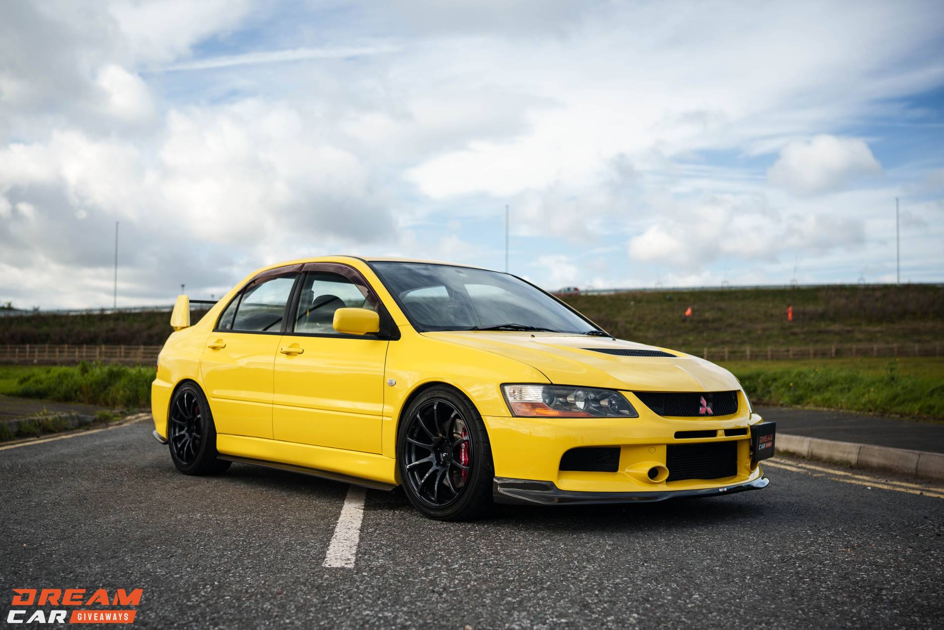 Win this Wasp Yellow Mitsubishi Evo 9 & £1,000